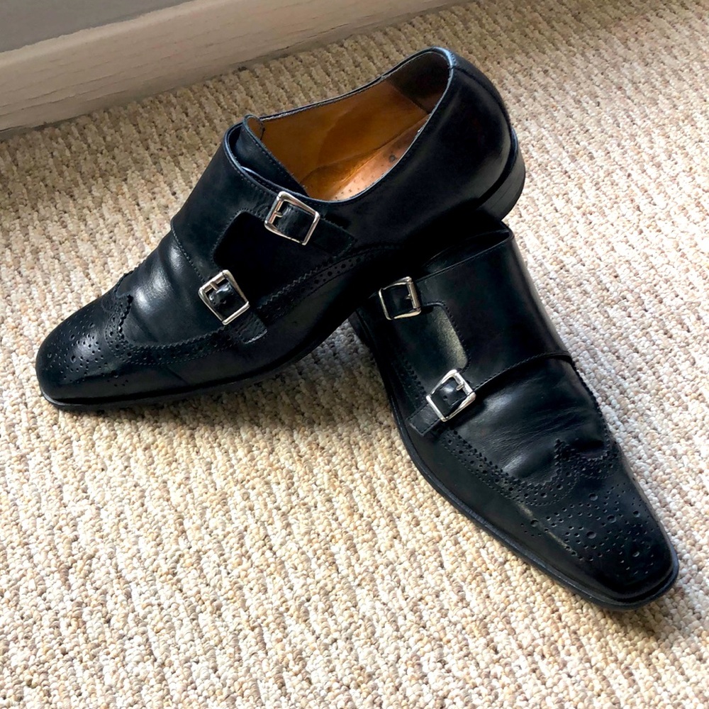 Black double-monk strap wingtip shoes